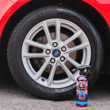 Tyre Gloss bottle in front of a wheel