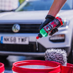 Luxury Suds Shampoo being poured into a Wash Bucket