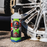 Bottle of wheel and tyre cleaner in front of a wheel